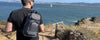 a man looking out at the water wearing Erozul Equinox Smell Proof Sling Bag