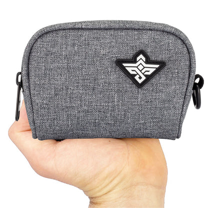 A hand holds the Erozul Nano Small Smell Proof Slim Pack Pouch V2.0, a grey pouch with a black-and-white geometric logo, water-resistant fabric, black side clips, and advanced 5-layer protection technology.