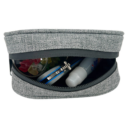 The Erozul Nano Small Smell Proof Slim Pack Pouch V2.0 in gray, featuring 5-layer technology, is partially open and holds a toothbrush, toothpaste, and other small personal care items.