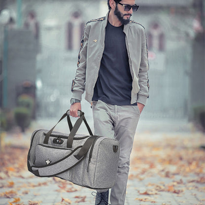 A man in sunglasses and a gray outfit walks outdoors on a leaf-covered path, carrying the Erozul Legion Smell Proof Duffle Bag with Combination Lock, featuring black straps.