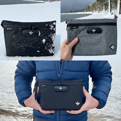 The Erozul Orion Smell Proof Bag With Combination Lock 11 is shown outdoors near a snowy lake—displayed on snow and held by someone in a blue jacket.